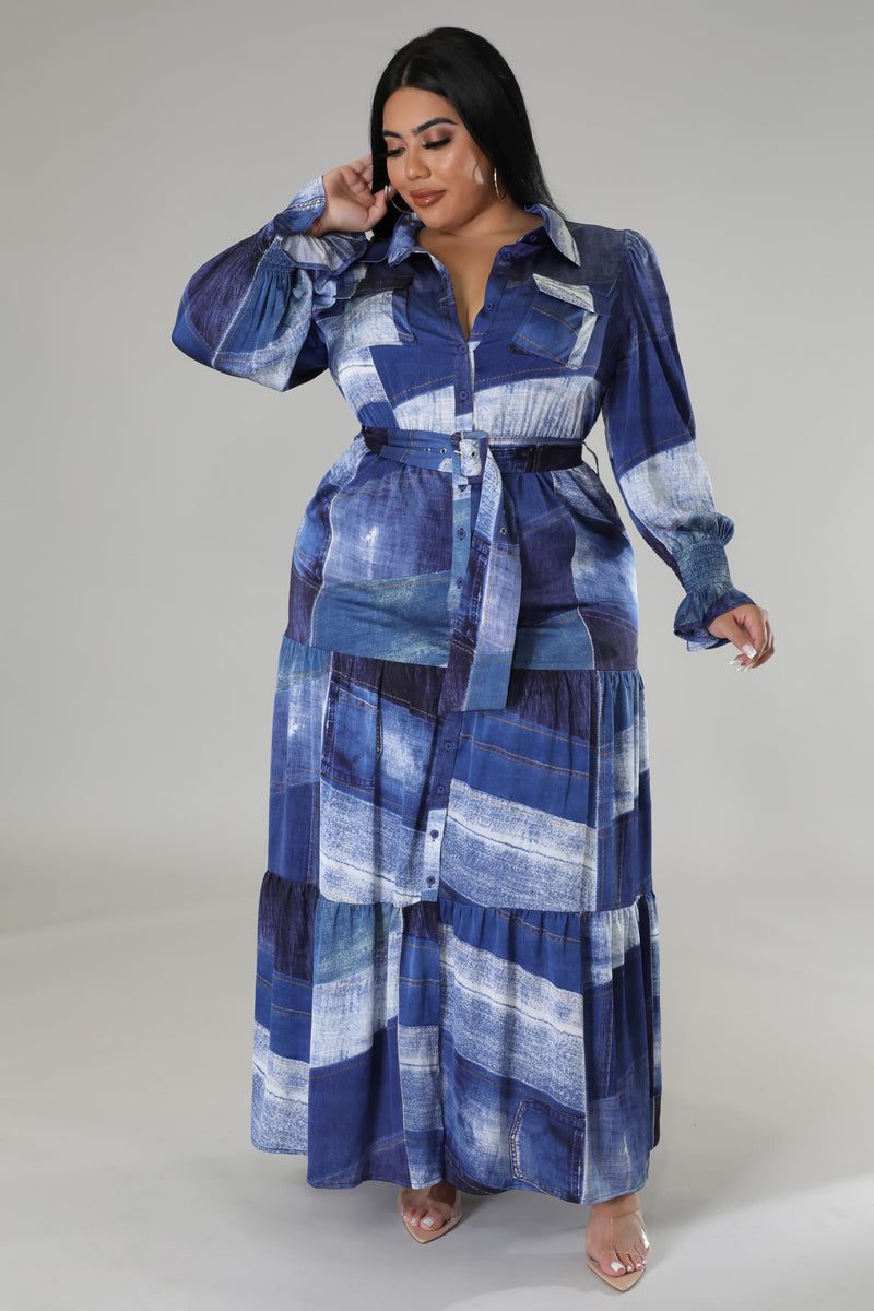 In a stunning blue dress, a woman embraces her curves with confidence.